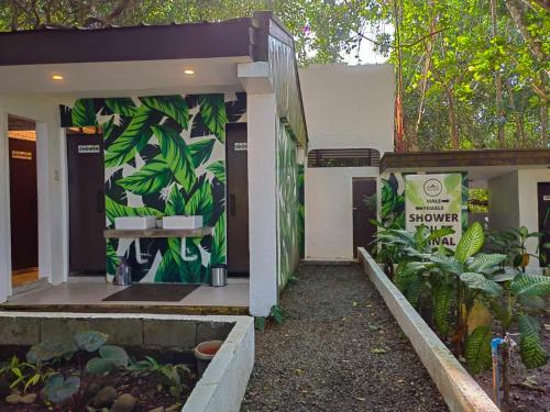 a building with a mural of plants on the wall at Kaliraya Surf Kamp by Eco Hotels in Cavinti