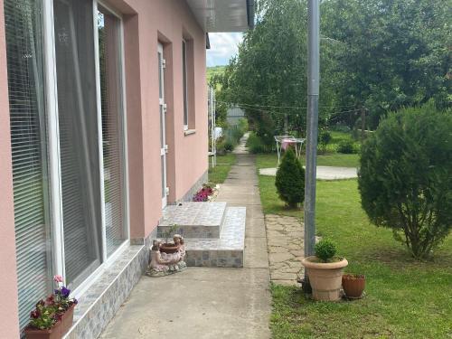 a porch of a pink house with a window at Будинок для відпочинку Dana in Berehove