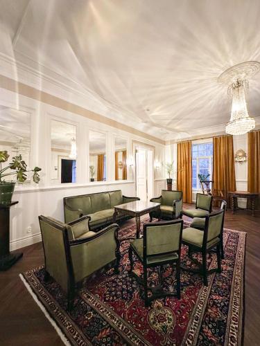 a living room with couches and a table and chairs at Strandnäs Gård in Mariehamn