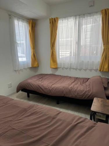 Postel nebo postele na pokoji v ubytování Systemcoat Oodouri East 102