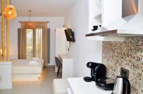 a kitchen and living room with a counter top at Lilian Studios in Koufonisia