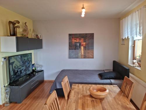 a bedroom with a bed and a table and chairs at Holiday House PANORAMA in Podčetrtek