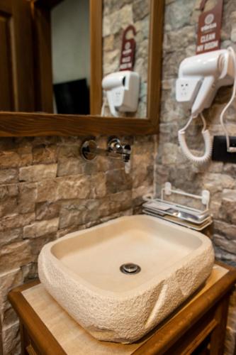a bathroom sink with a soap dispenser above it at Vista Boutique Hotel in Berat