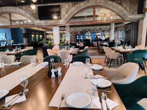 a dining room with tables and chairs and a restaurant at Millenium Palace in Ohrid