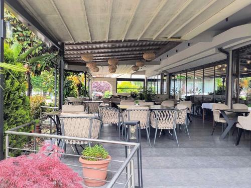 a restaurant with tables and chairs and windows at Millenium Palace in Ohrid