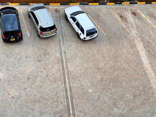 two cars parked in a parking lot next to each other at Luxurious 2 bedroom penthouse-Fully Furnished at 360 Luxury in Kitale