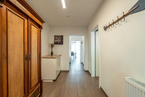 a hallway of a home with white walls and wood floors at Sellinkoje in Residenz Waldidyll in Ostseebad Sellin