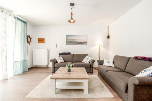 a living room with two couches and a coffee table at Sellinkoje in Residenz Waldidyll in Ostseebad Sellin