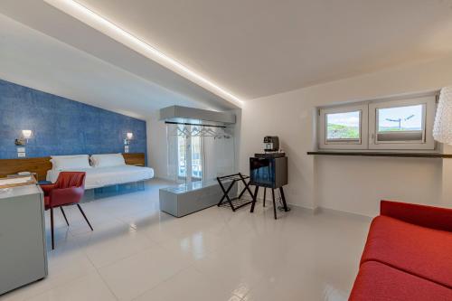 a bedroom with a bed and a tv in it at Aquamaris Design Suite & Spa in Paestum