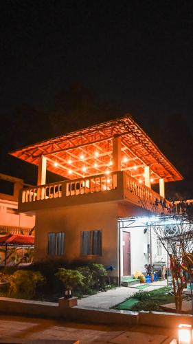a building with lights on top of it at night at Damodar River Retreat, Uluberia in Uluberiya