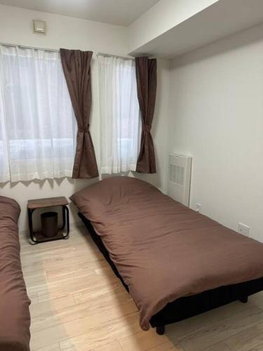 Postel nebo postele na pokoji v ubytování Systemcoat Oodouri East 103