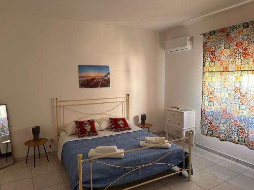 法維尼亞納的住宿－A Due Passi dal Centro，一间卧室配有一张带蓝色床单和红色枕头的床。