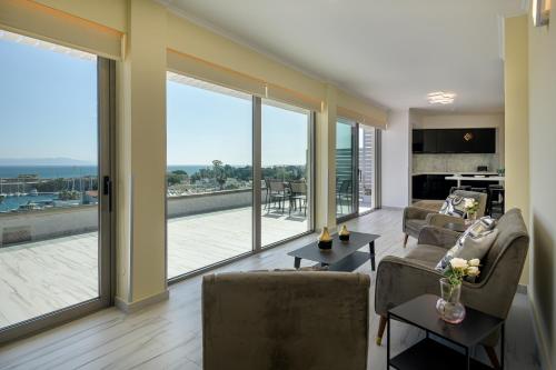 a living room with sliding glass doors and a living room at Alexandra Hotel&Apartments in Kos Town