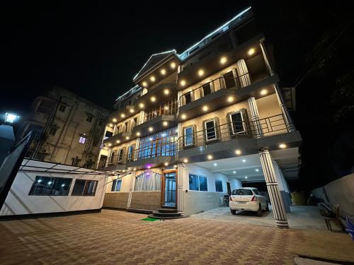 a building with a car parked in front of it at night at THE VISTA RESIDENCY in Guwahati