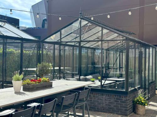 a patio with a table and chairs and a greenhouse at Best Western Malmo Arena Hotel in Malmö