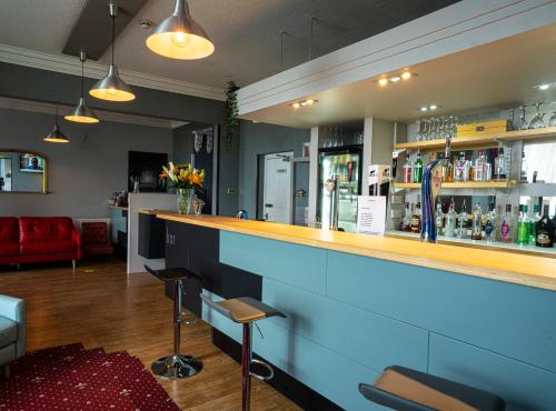 a bar with a blue counter in a room at The Central Hotel in Llandudno