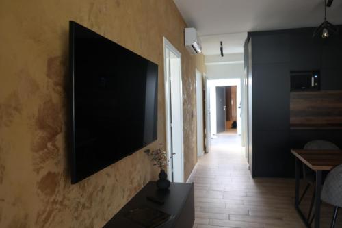 a flat screen tv hanging on a wall at Apartmani Royal Osijek in Osijek