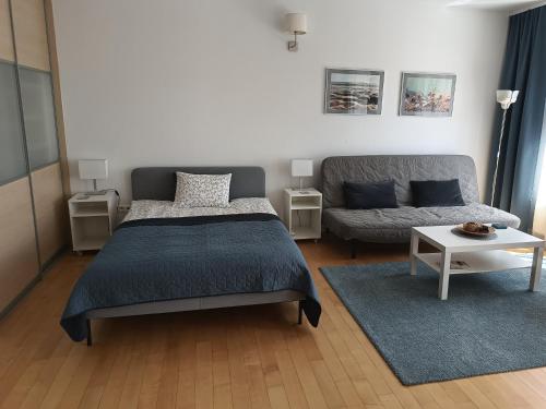 a bedroom with a bed and a couch at Apartament Zdrój in Krzeszowice