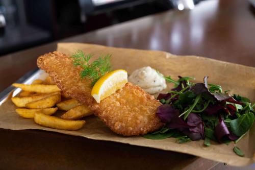 a plate of food with fish and french fries and a salad at Best Western Hotel Varnamo in Värnamo