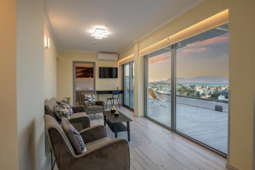 a living room with chairs and a living room with a balcony at Alexandra Hotel&Apartments in Kos Town