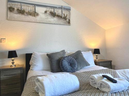 a bedroom with a bed with towels on it at Simpson Beach View Apartments by Blackpool Service Apartments in Blackpool