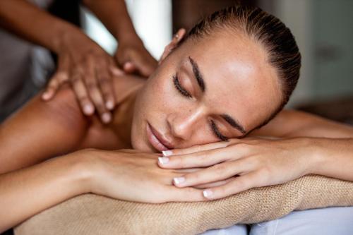 a woman getting a massage from a therapist at The Grand Luang Prabang, Affiliated by Meliá in Luang Prabang