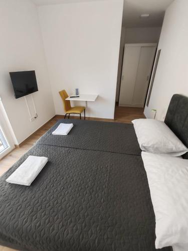 a bedroom with a large bed and a couch at Adriatica in Zadar