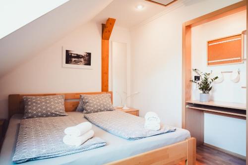 a small bedroom with a bed with towels on it at Chata Adélka in Boží Dar