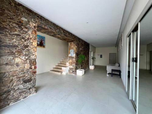 a hallway with a stone wall and a stone staircase at Acacias Rubras in Ferreira do Zêzere