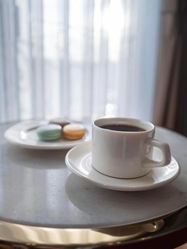 a cup of coffee and a plate of donuts on a table at New Inn Hotel Old Town in Istanbul