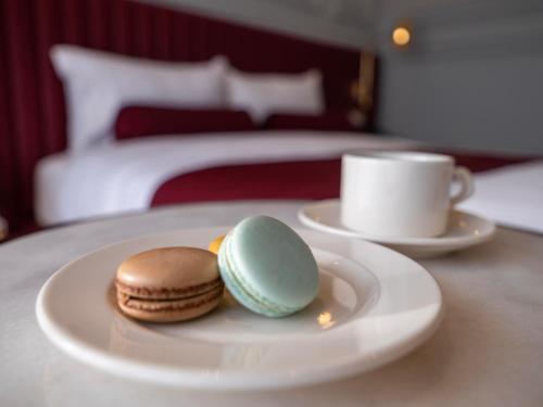 a plate with cookies and a cup of coffee on a table at New Inn Hotel Old Town in Istanbul