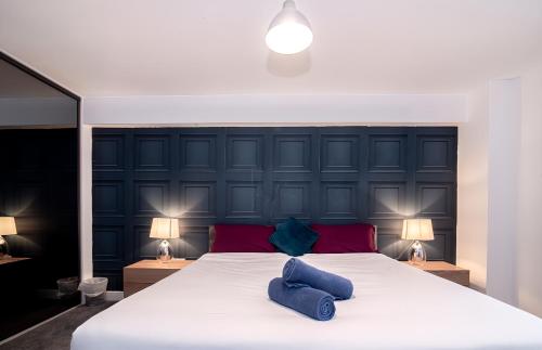 a bedroom with a large bed with two blue pillows at Stunning Apartment in Birmingham in Birmingham