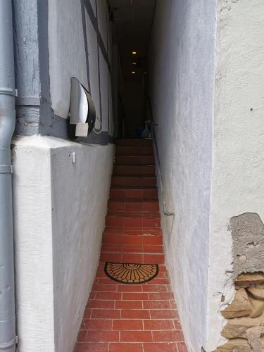 a hallway with a staircase with a drain on the floor at Im Herzen des Kraichgaus 2 in Östringen
