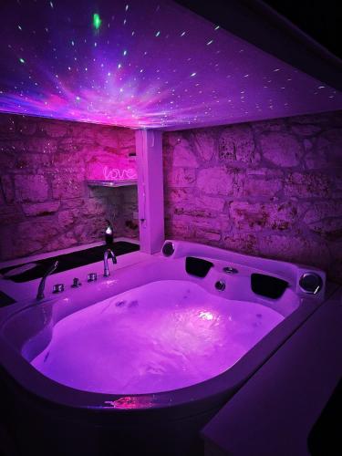 a bath tub with purple lights in a room at Deluxe in Alberobello