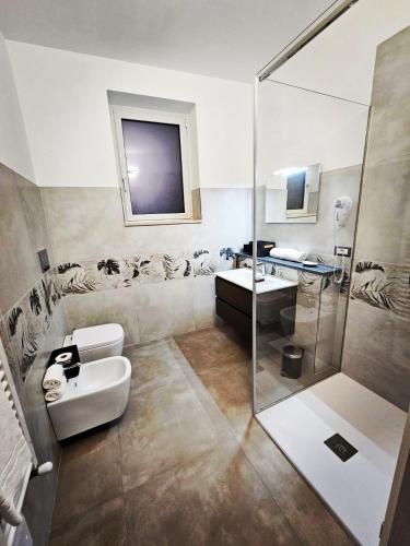 a bathroom with a shower and a toilet and a sink at Deluxe in Alberobello