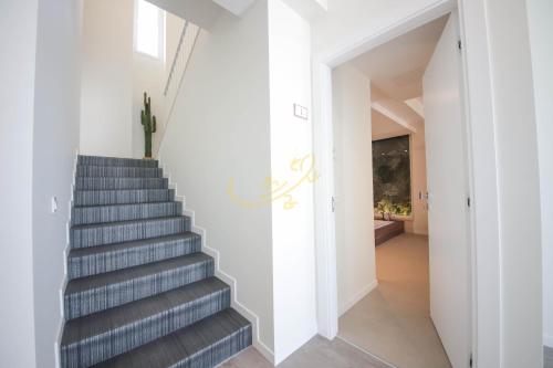 a staircase in a home with white walls and a stair case at Alberobbè luxury rooms in Alberobello