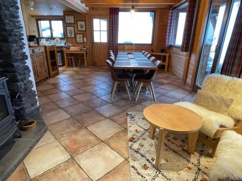 a living room with a table and a dining room at Chalet Tavernier in Morzine