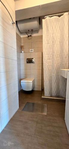a bathroom with a toilet and a sink at Premium Sea View in Nea Potidaea