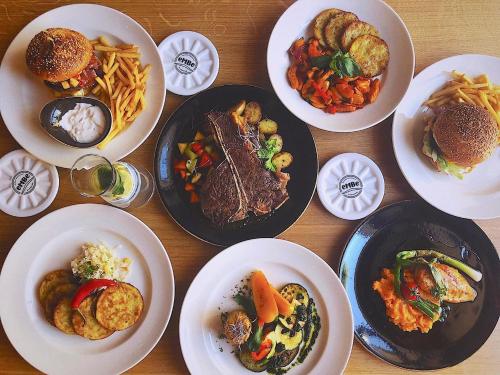 a wooden table with plates of food on it at River Apartments in Mladá Boleslav