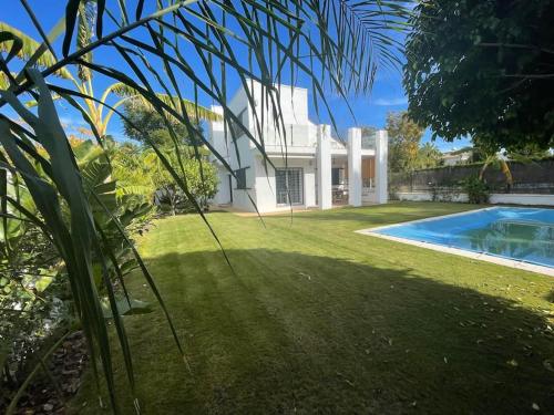 a house with a swimming pool in front of a yard at Sunset Villa Arcos in Arcos de la Frontera
