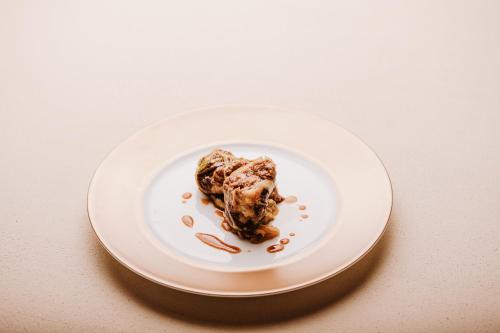 a white plate with chocolate ice cream on it at Locanda Solagna in Quero
