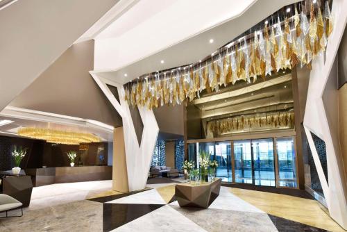 a lobby of a hotel with a chandelier at Hilton Bahrain in Manama