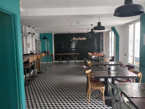 a dining room with tables and chairs and a chalkboard at Arty Paris Porte de Versailles by River in Paris