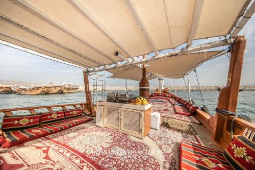 a boat on the water with lots at Overnight Dhow - 1 Night 2 Days in Khasab