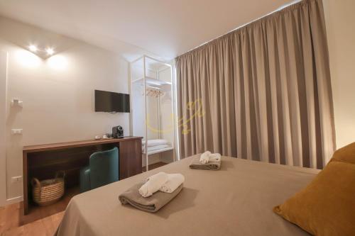 a hotel room with a bed with towels on it at Alberobbè luxury rooms in Alberobello