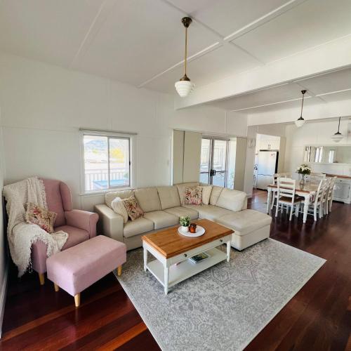a living room with a couch and a table at Savina Cottage in Stanthorpe