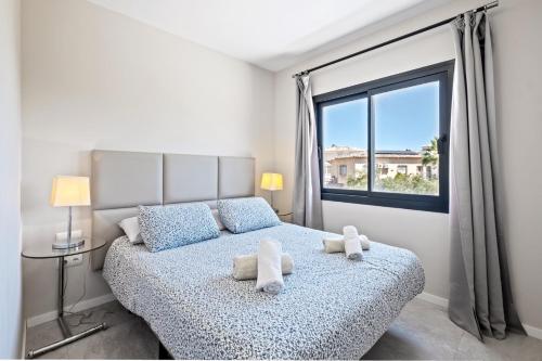 a bedroom with a bed with two stuffed animals on it at Amazing Villa in El Faro in Fuengirola
