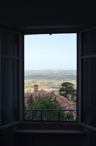 a window in a room looking out at a view at AlbaLuna - panorama sulle Langhe in Guarene