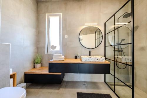 a bathroom with a sink and a mirror at Villa Sunset Grusi ZadarVillas in Briševo