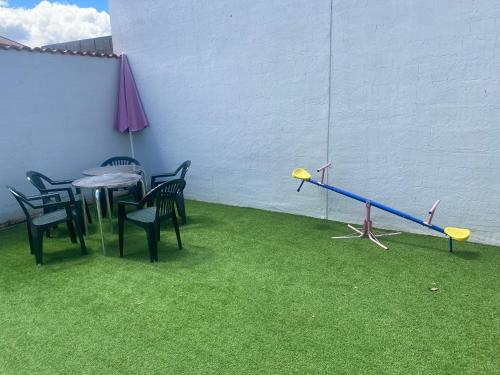 a room with a table and chairs and a seesaw at CASA RURAL VEGASAN in Santa Colomba de la Vega